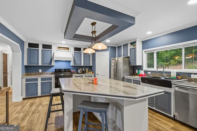 a kitchen with stainless steel appliances granite countertop a stove refrigerator and cabinets