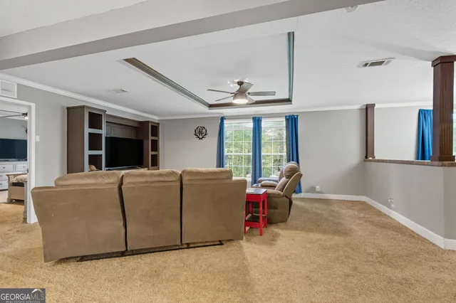 a living room with furniture window and flat screen tv