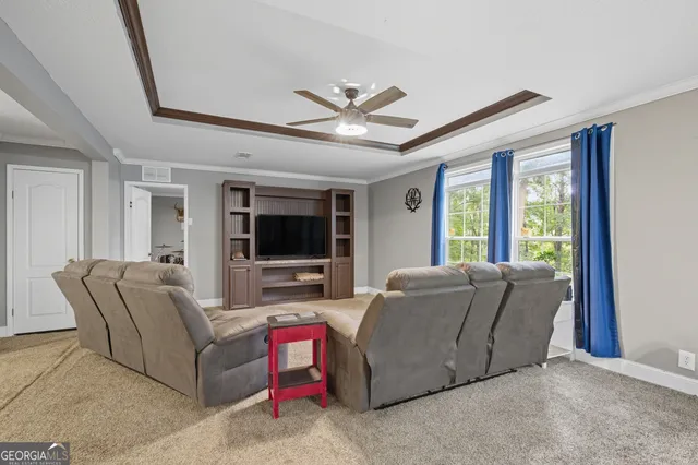a living room with furniture and a flat screen tv