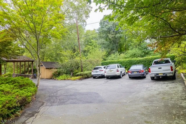 a kitchen with stainless steel appliances granite countertop sink stove refrigerator dining table and chairs
