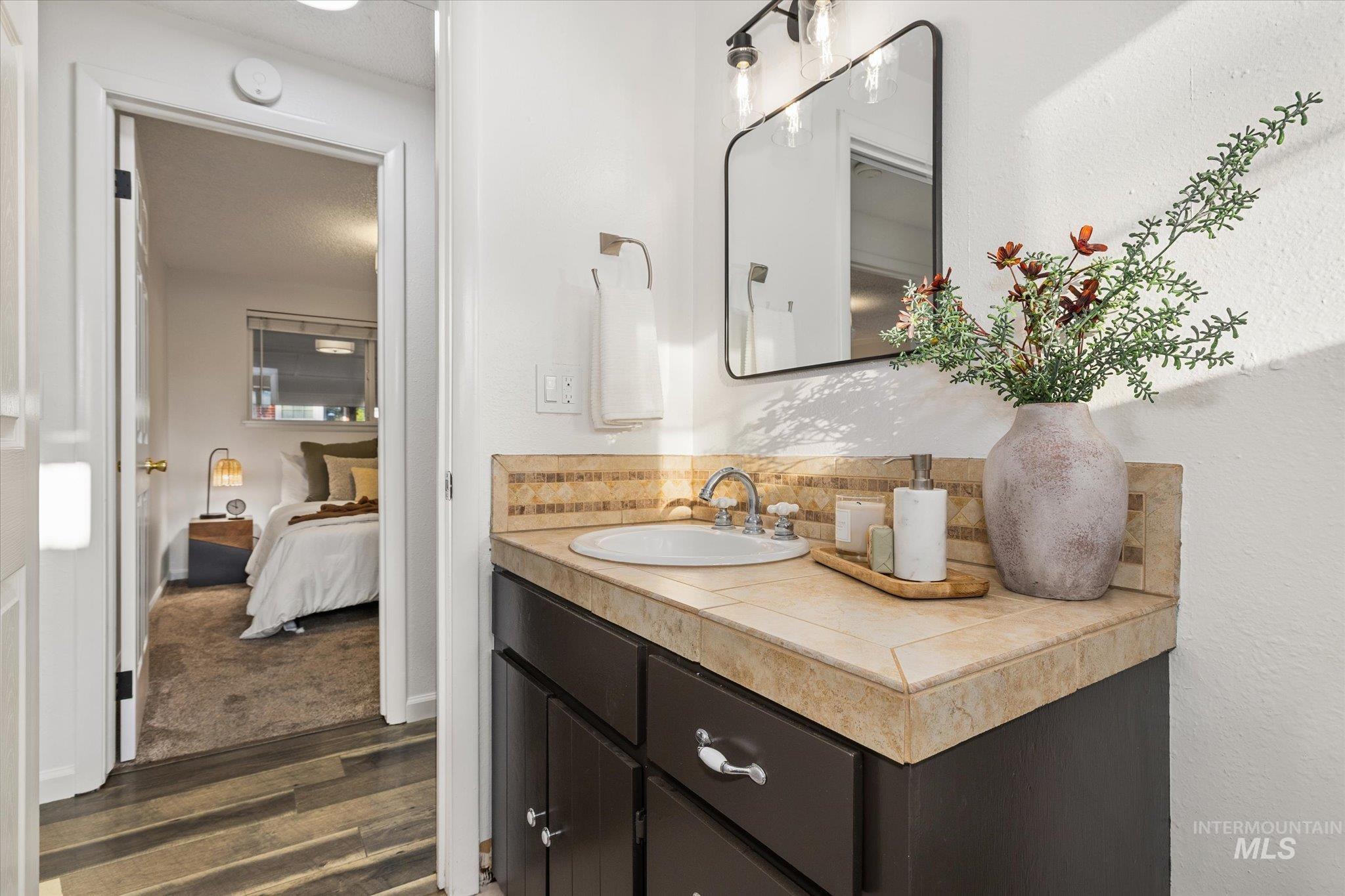 2302 Pendleton Street Boise, ID 83705 - Photo 23 of 35 Bathroom vanity with a tiled countertop, undermount sink, and a framed mirror