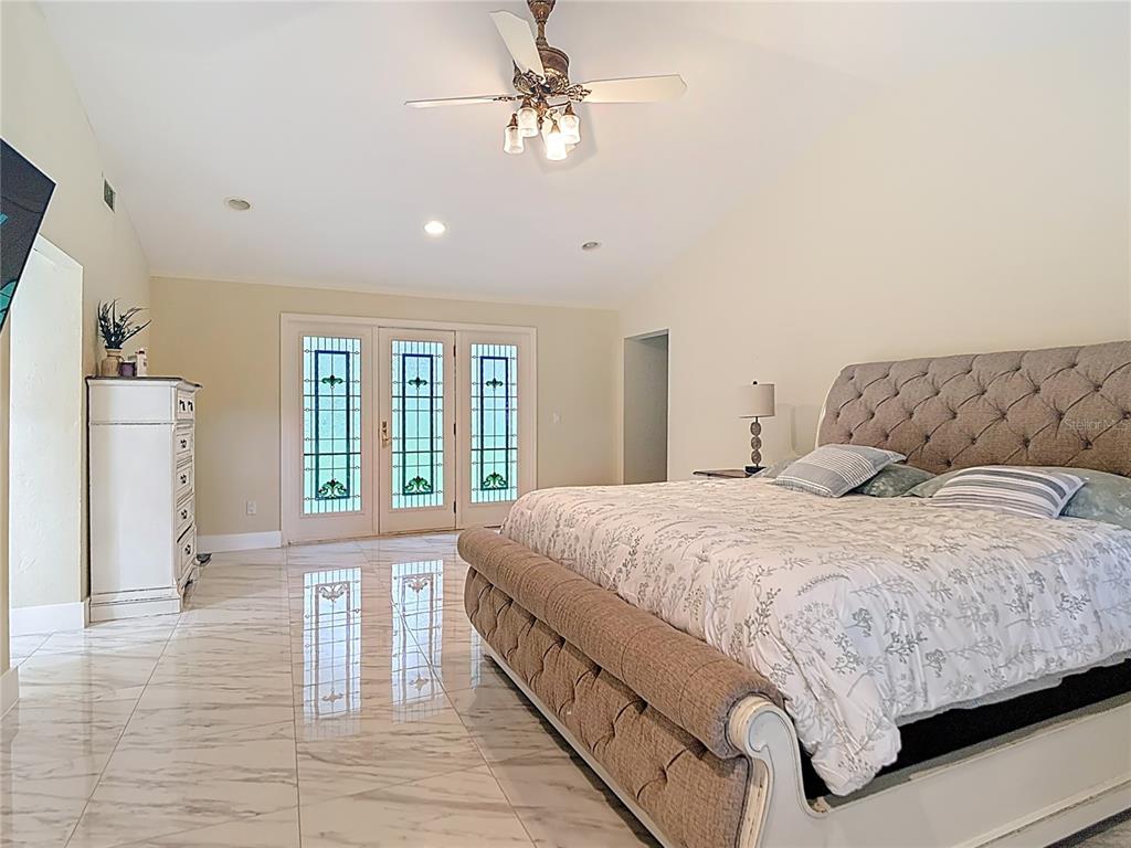 2130 Southwest 37th Street Road Ocala, FL 34471 - Photo 13 of 33 a bedroom with a large bed and a window