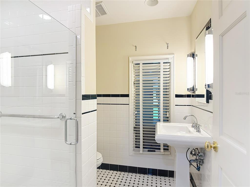 2130 Southwest 37th Street Road Ocala, FL 34471 - Photo 22 of 33 a bathroom with a sink a mirror and a shower