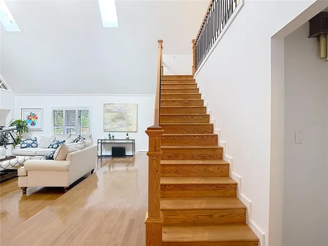 a view of entryway and hall with wooden floor