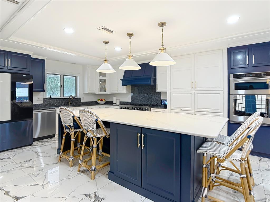 2130 Southwest 37th Street Road Ocala, FL 34471 - Photo 8 of 33 a kitchen with kitchen island granite countertop a sink a center island and cabinets
