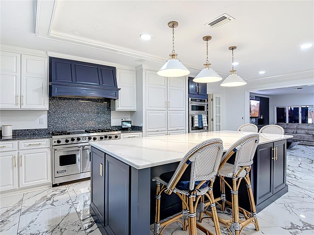 2130 Southwest 37th Street Road Ocala, FL 34471 - Photo 9 of 33 a kitchen with a table chairs stainless steel appliances and cabinets
