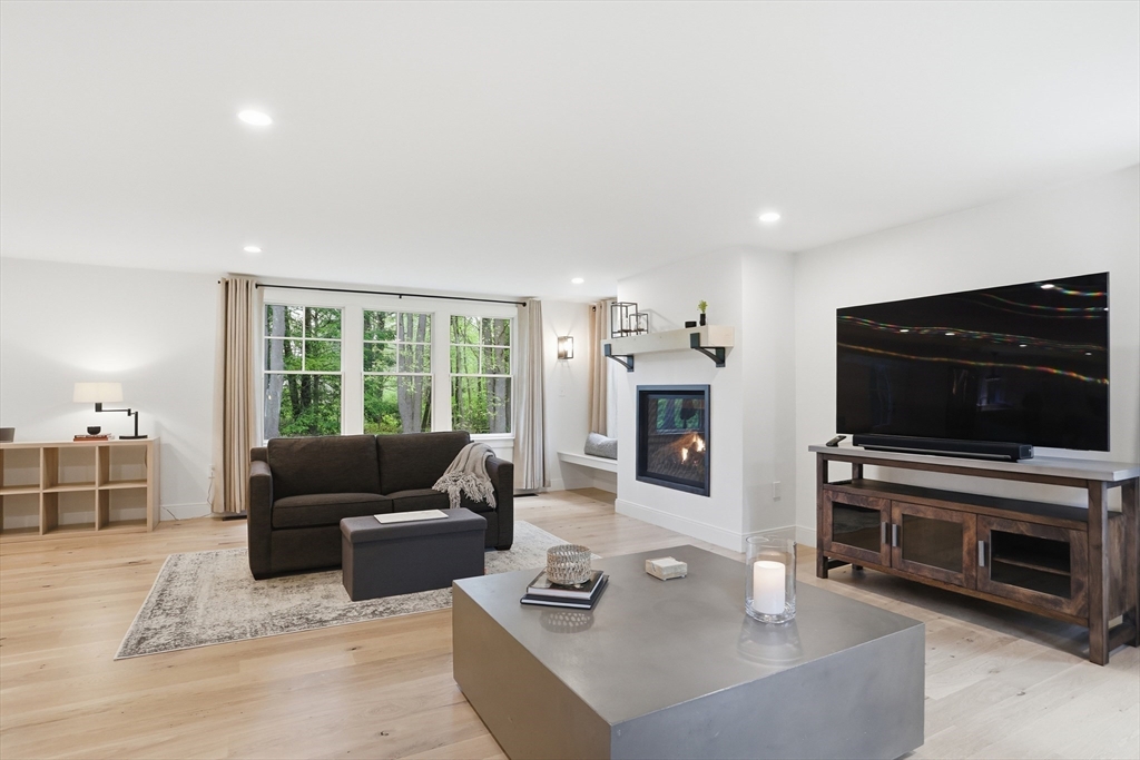 136 Holden Wood Road Concord, MA 01742 - Photo 8 of 31 a living room with furniture and a flat screen tv