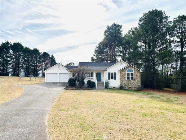 a view of a house with a yard and trees