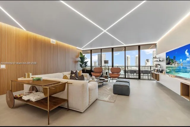 a living room with fireplace furniture and a large window