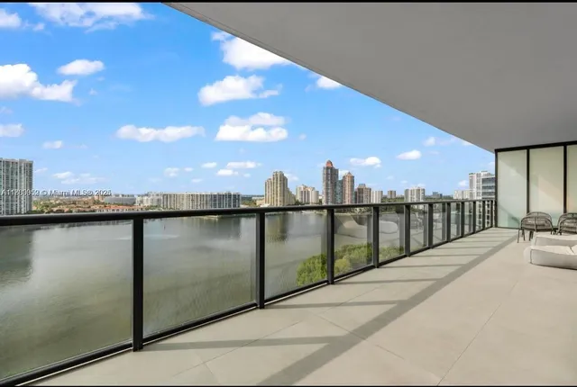 a spacious bedroom with a bed couch and a view of living room