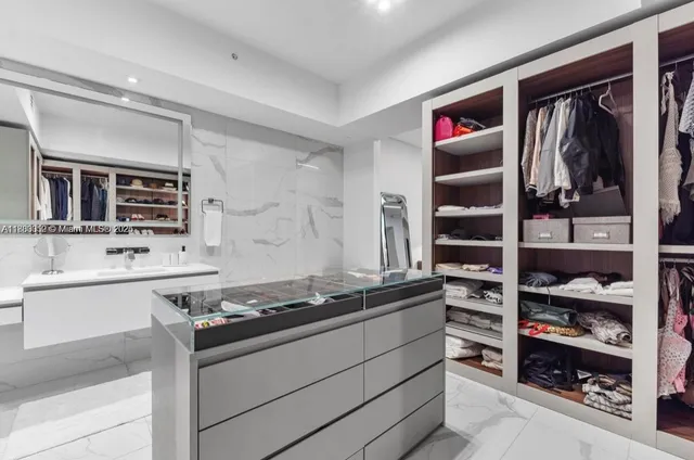 a bedroom with a large bed and a balcony