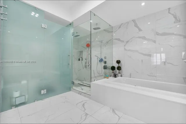 a bathroom with a sink mirror shower and toilet