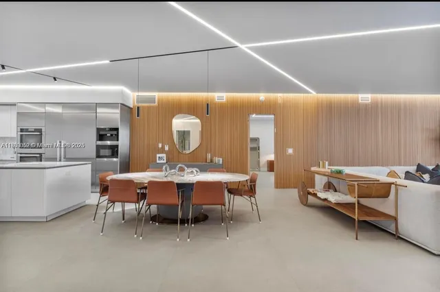 a view of a dining room with furniture and a large window