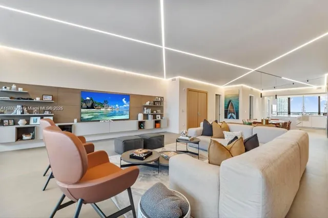 a living room with patio furniture and a potted plant