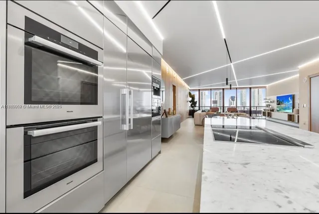 a view of a kitchen with a sink and stainless steel appliances