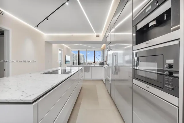a kitchen with stainless steel appliances granite countertop a sink and cabinets