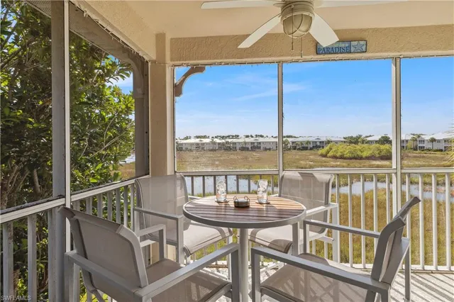 a view of a balcony with chair and wooden floor