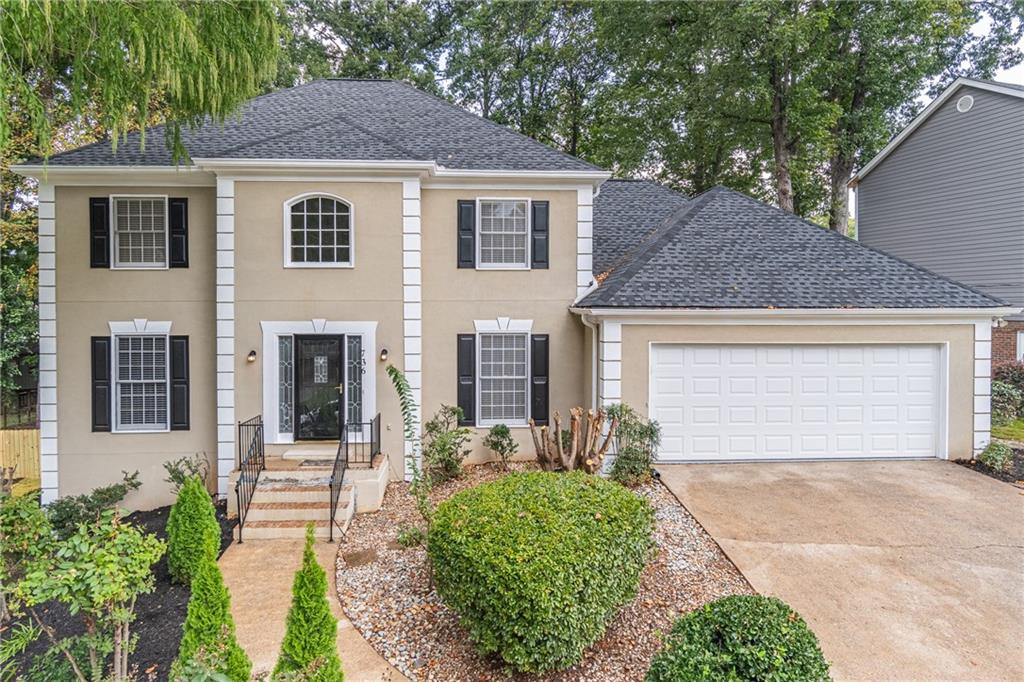 736 Singley Drive Lawrenceville, GA 30044 - Photo 1 of 33 a front view of a house with a yard and garage