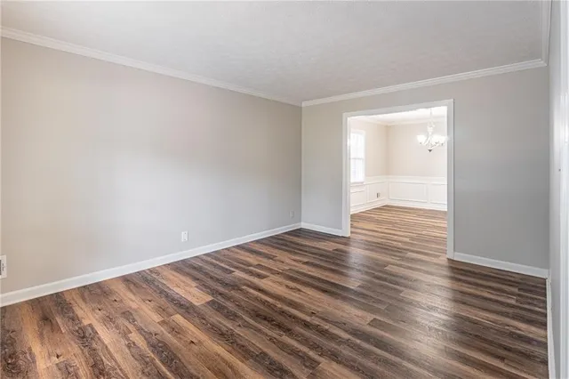 a view of an empty room and wooden floor