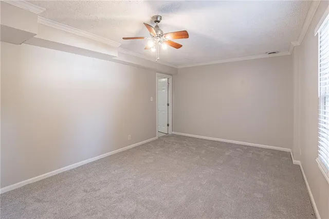 an empty room with closet and ceiling fan