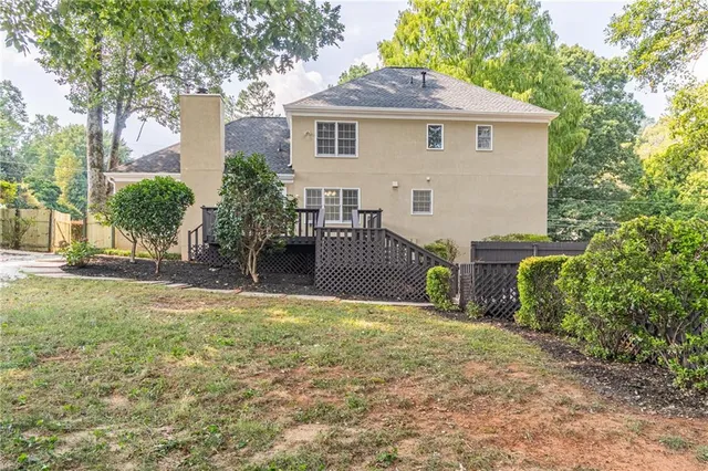 a view of a gate with a fence and trees