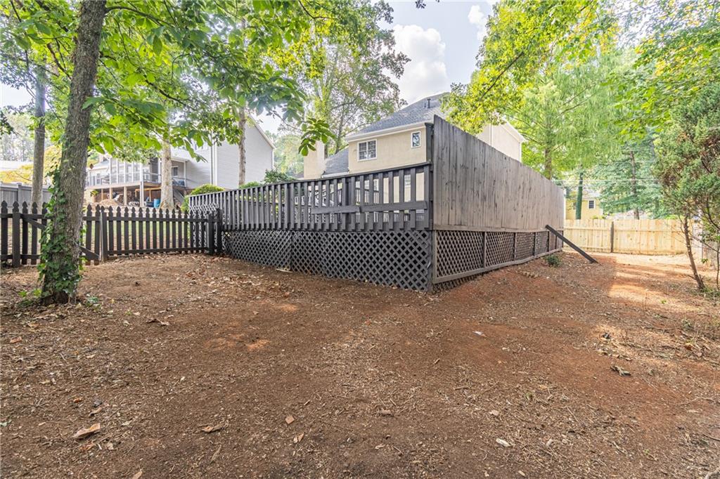 736 Singley Drive Lawrenceville, GA 30044 - Photo 33 of 33 a view of a gate with a fence and trees