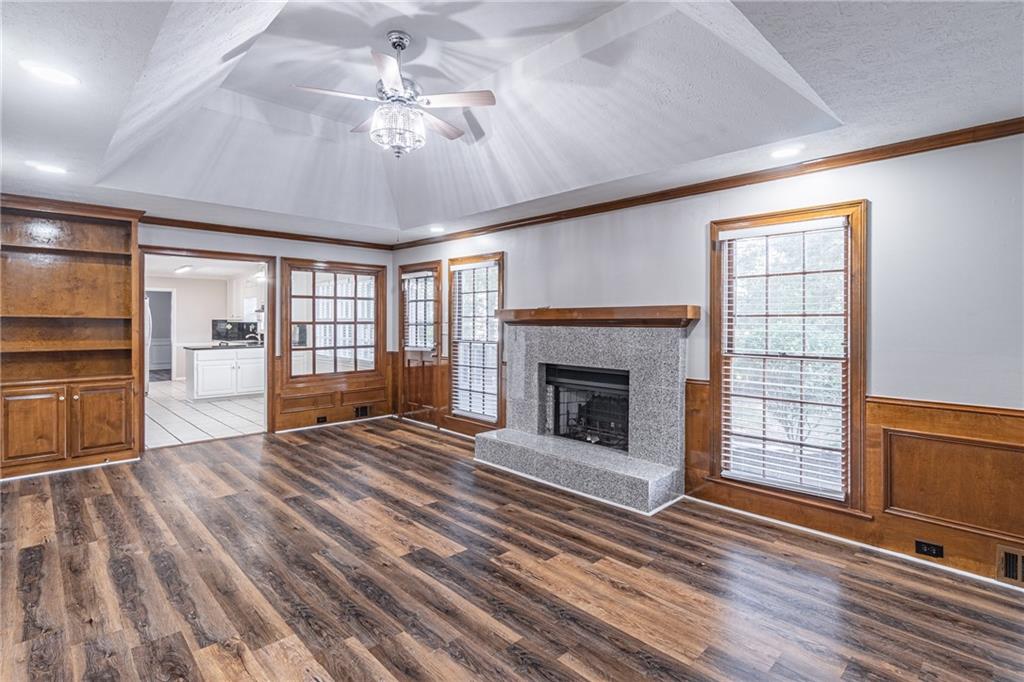 736 Singley Drive Lawrenceville, GA 30044 - Photo 5 of 33 a view of an empty room with wooden floor fireplace and a window