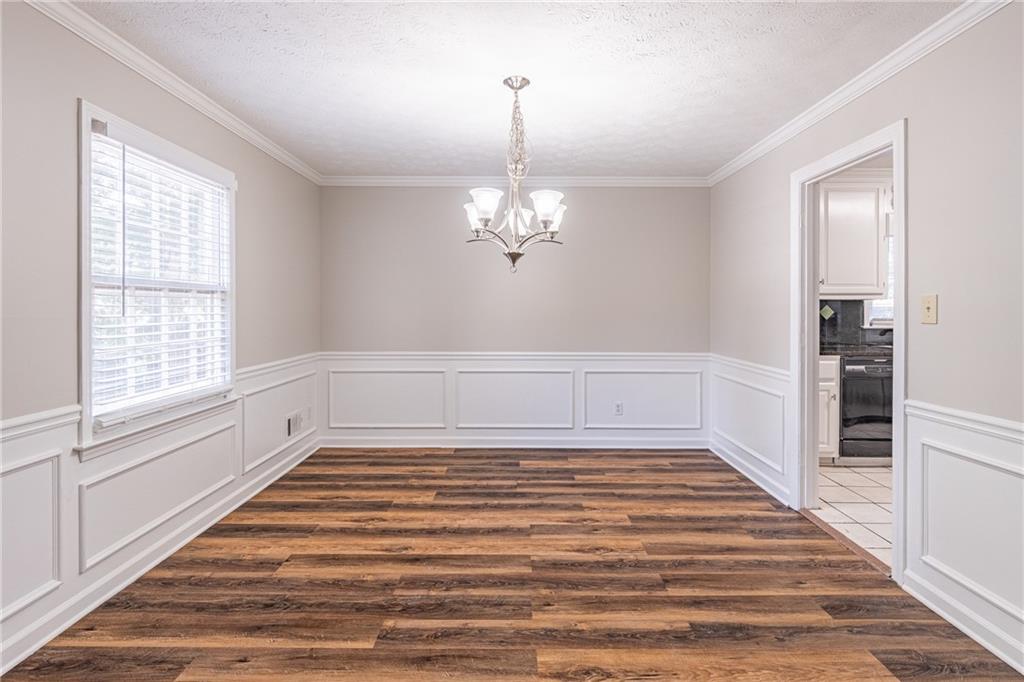 736 Singley Drive Lawrenceville, GA 30044 - Photo 10 of 33 a view of a room with wooden floor and staircase
