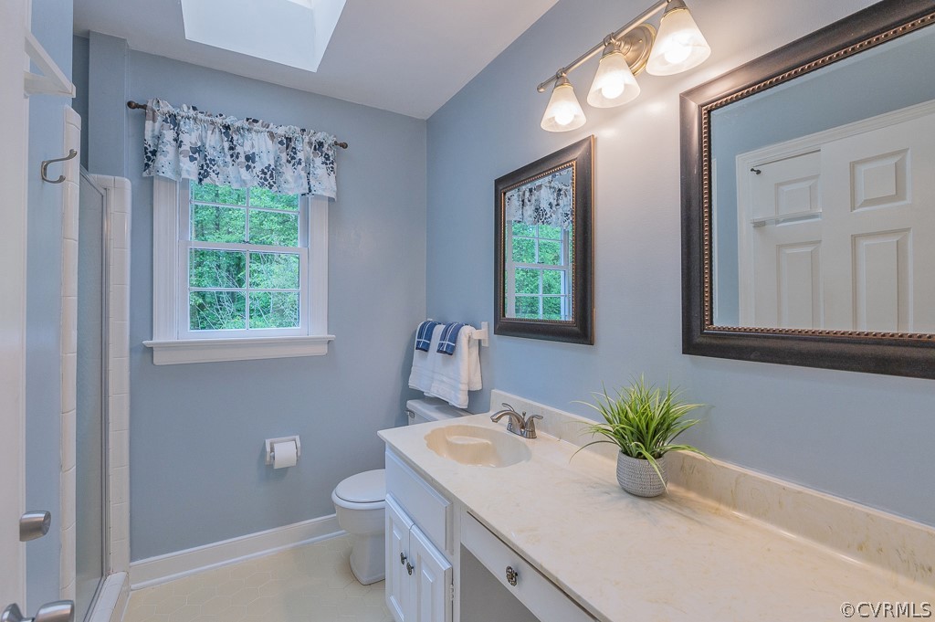 14202 Long Gate Road Midlothian, VA 23112 - Photo 18 of 27 a bathroom with a sink a mirror and a toilet