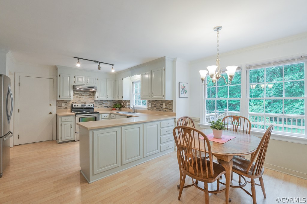 14202 Long Gate Road Midlothian, VA 23112 - Photo 7 of 27 a kitchen with granite countertop a table chairs stove and refrigerator