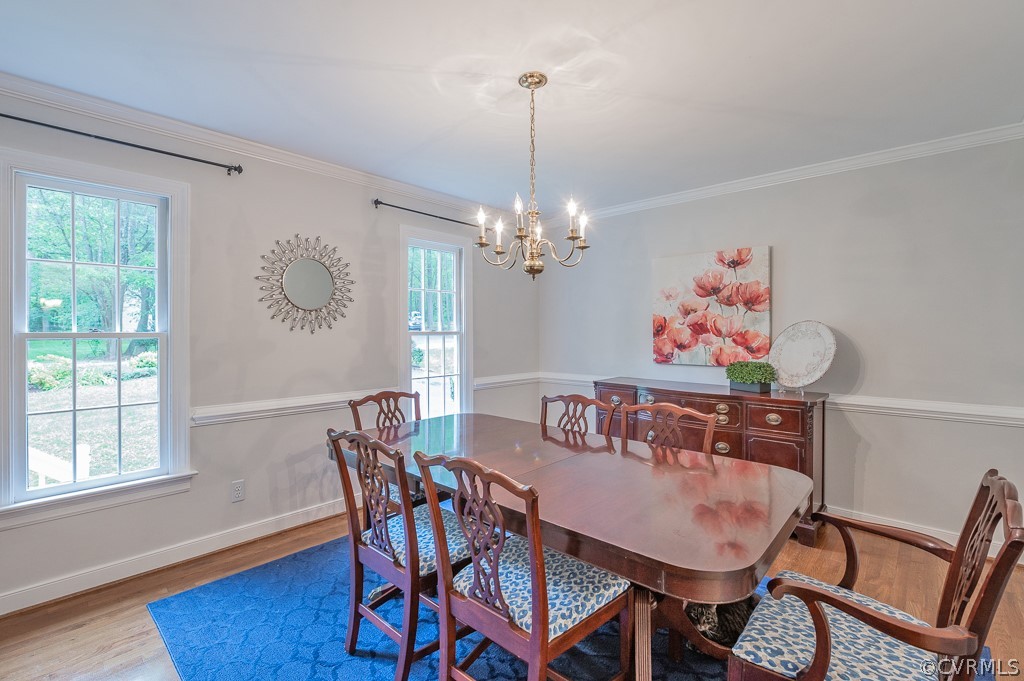 14202 Long Gate Road Midlothian, VA 23112 - Photo 8 of 27 a view of a dining room with furniture wooden floor and a chandelier