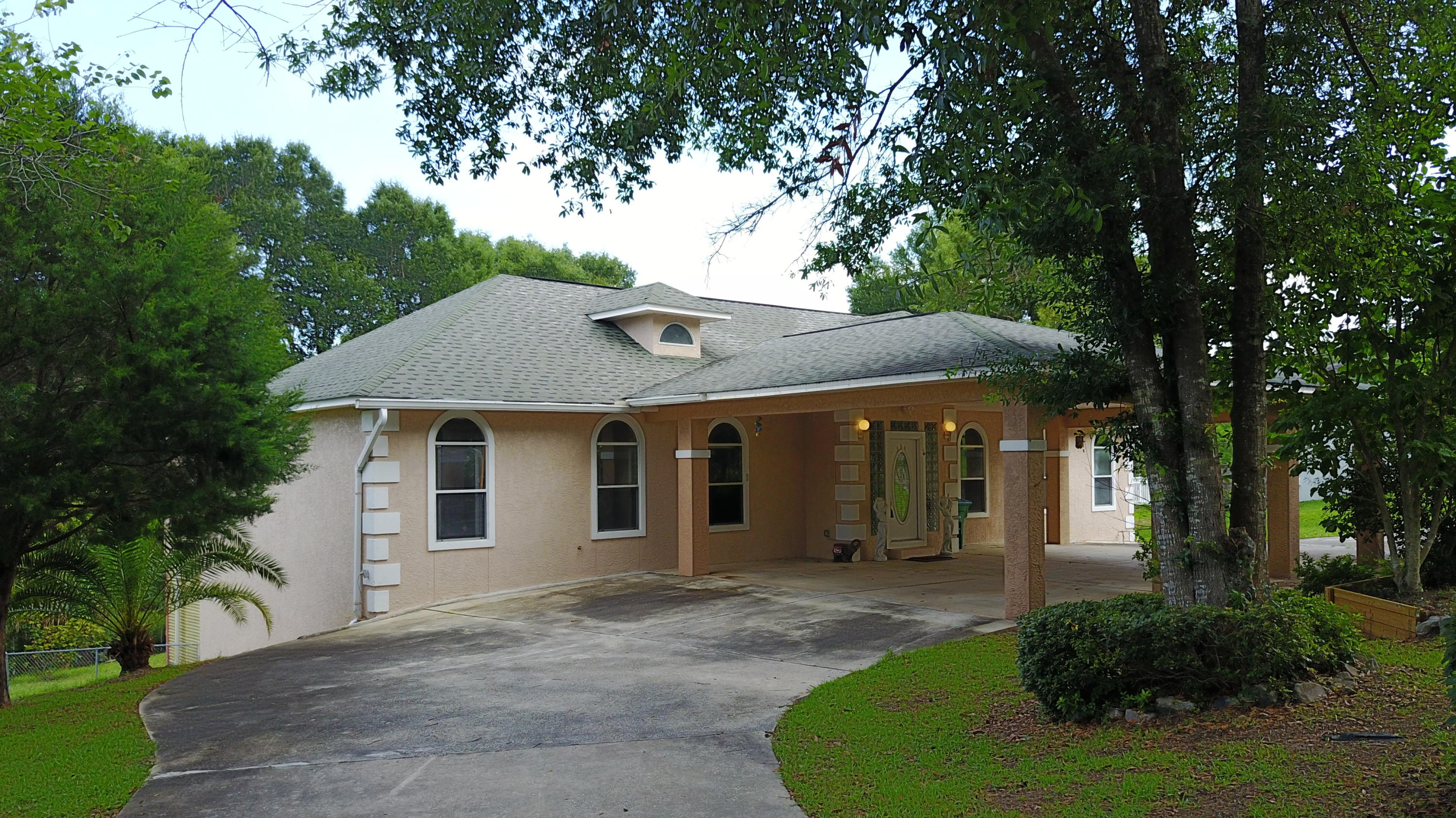 564 Ridge Lake Road Crestview, FL 32536 - Photo 1 of 58 a view of a white house with a big yard plants and large tree