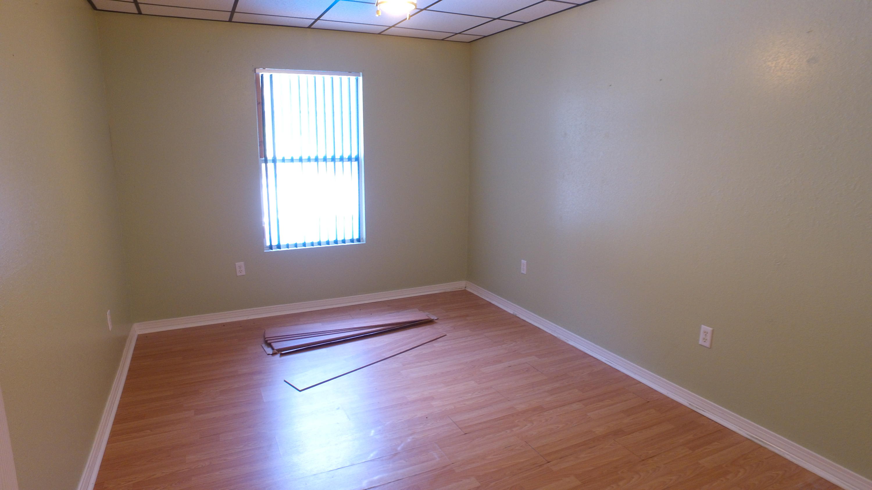 564 Ridge Lake Road Crestview, FL 32536 - Photo 11 of 58 an empty room with wooden floor and windows