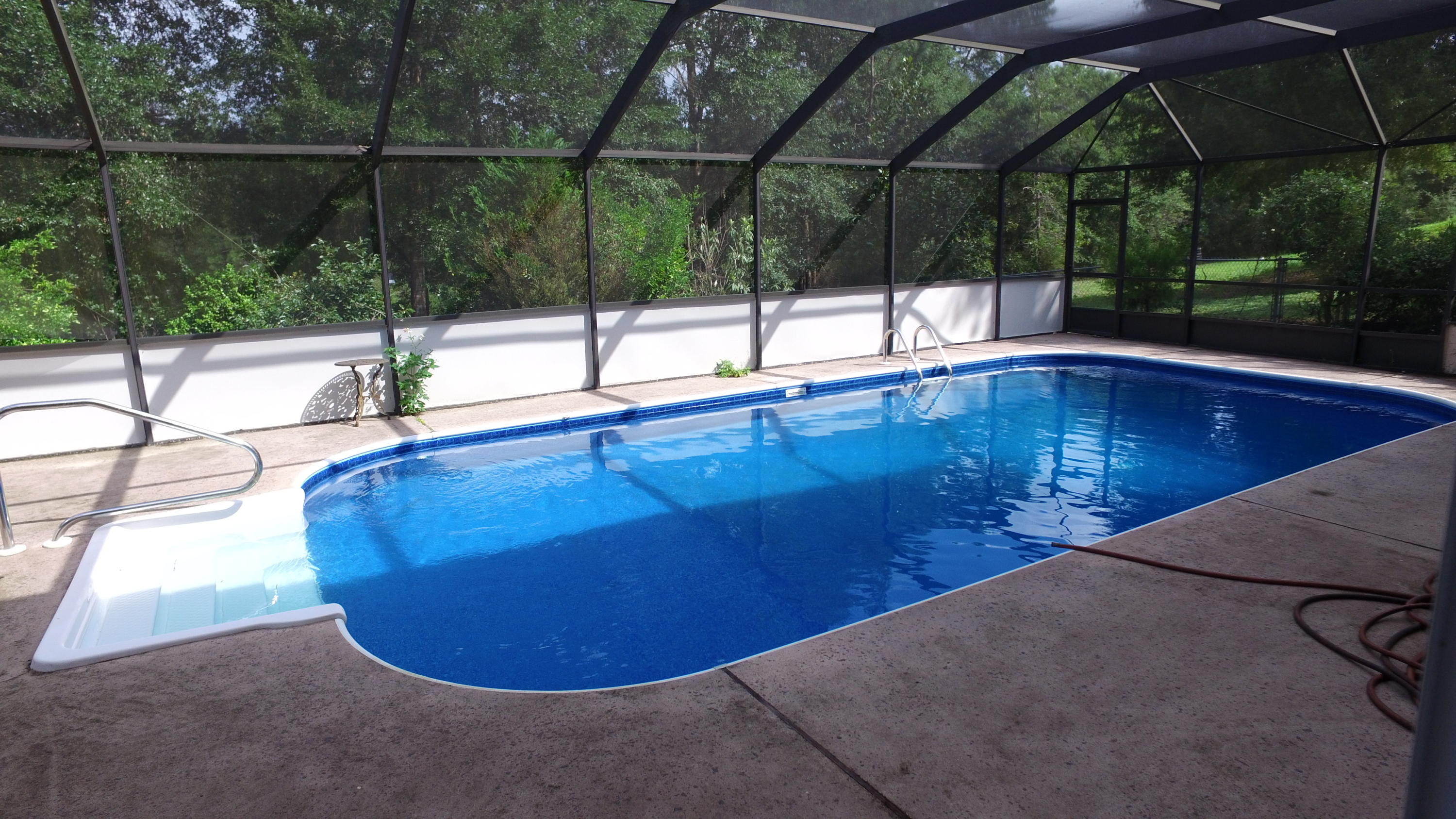 564 Ridge Lake Road Crestview, FL 32536 - Photo 16 of 58 a view of a swimming pool with a patio