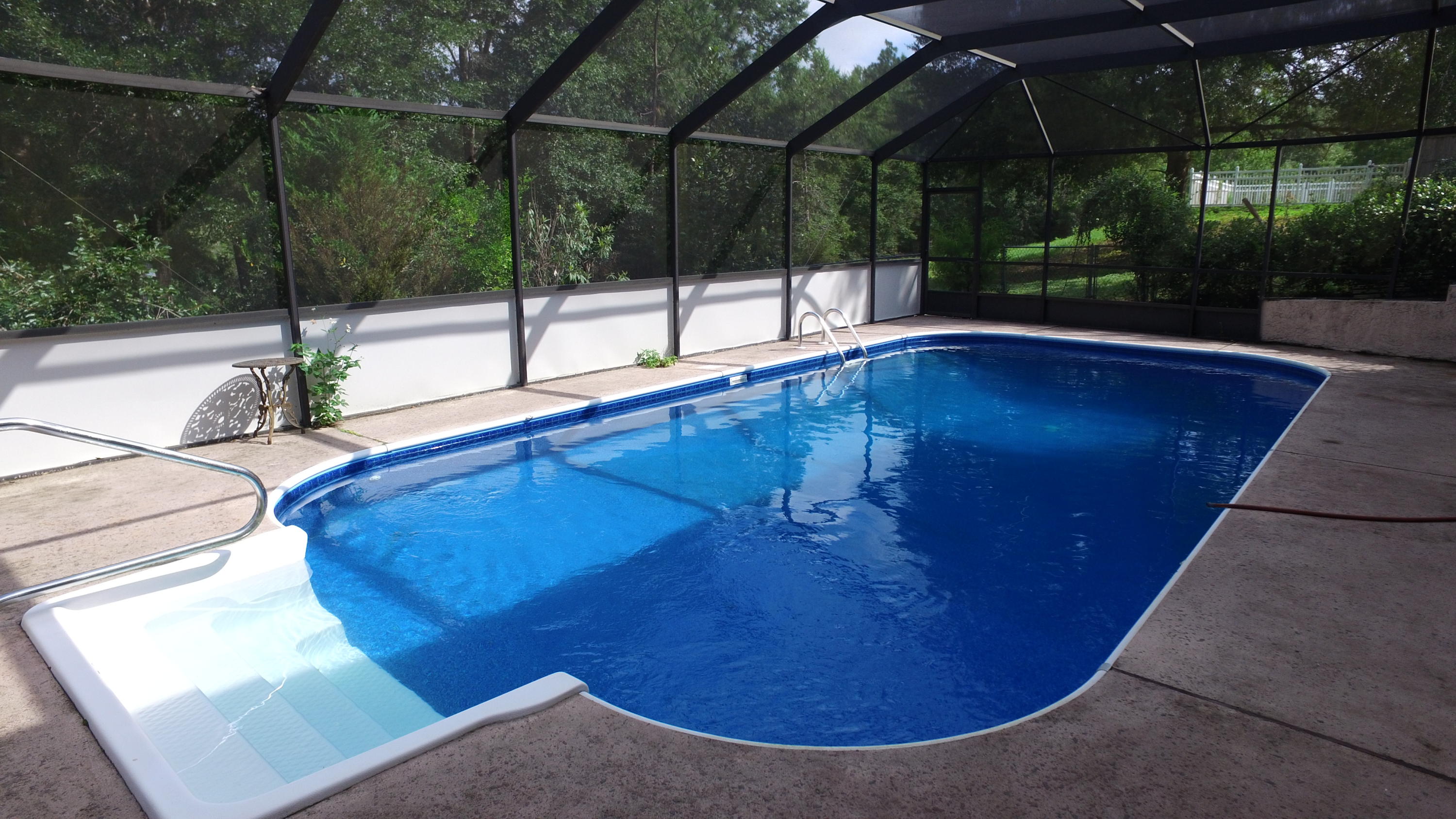 564 Ridge Lake Road Crestview, FL 32536 - Photo 17 of 58 a view of a swimming pool with a patio
