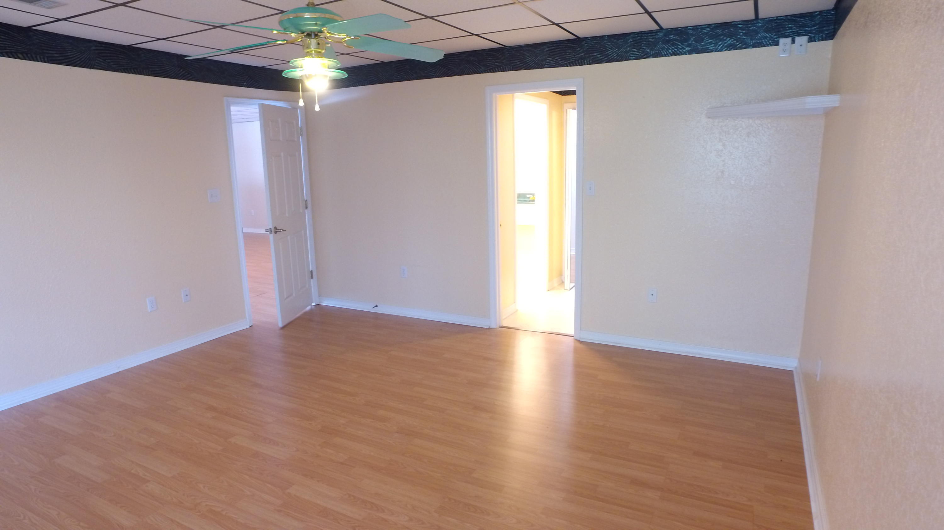 564 Ridge Lake Road Crestview, FL 32536 - Photo 19 of 58 an empty room with wooden floor and windows
