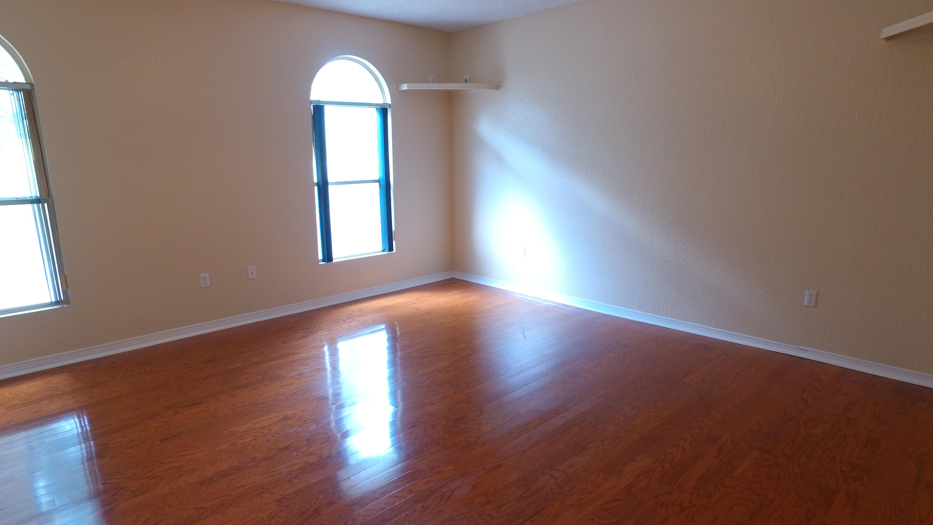 564 Ridge Lake Road Crestview, FL 32536 - Photo 29 of 58 an empty room with wooden floor and windows