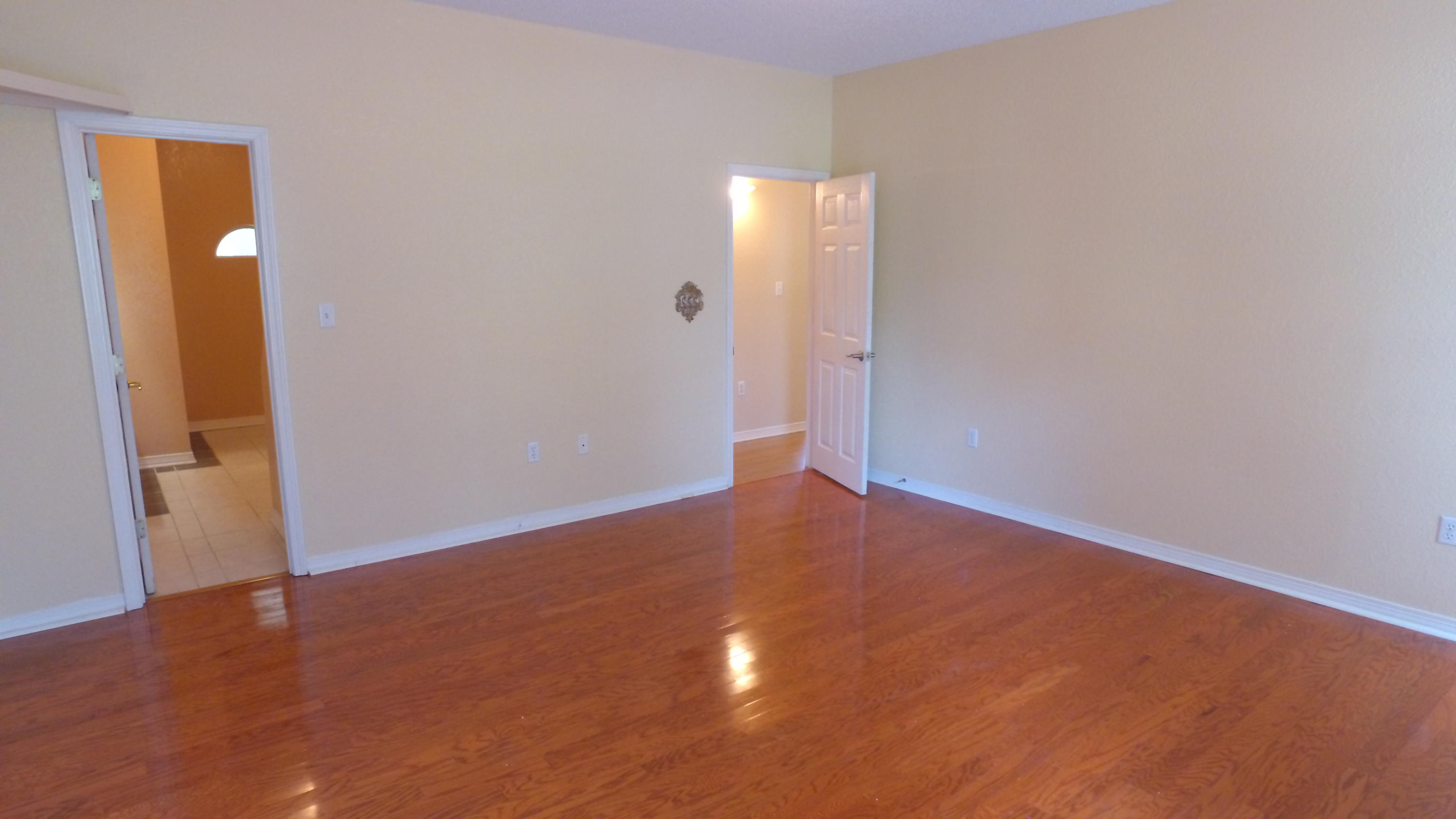 564 Ridge Lake Road Crestview, FL 32536 - Photo 30 of 58 an empty room with wooden floor and windows