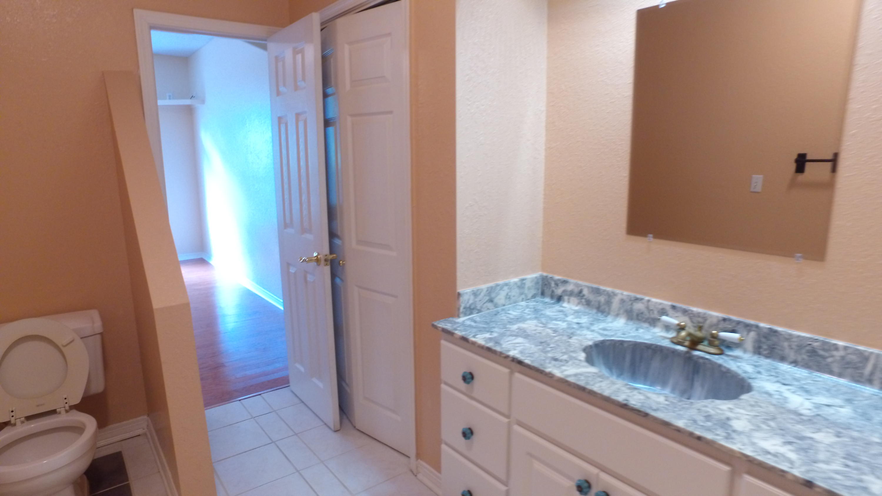 564 Ridge Lake Road Crestview, FL 32536 - Photo 32 of 58 a bathroom with a granite countertop sink and a mirror