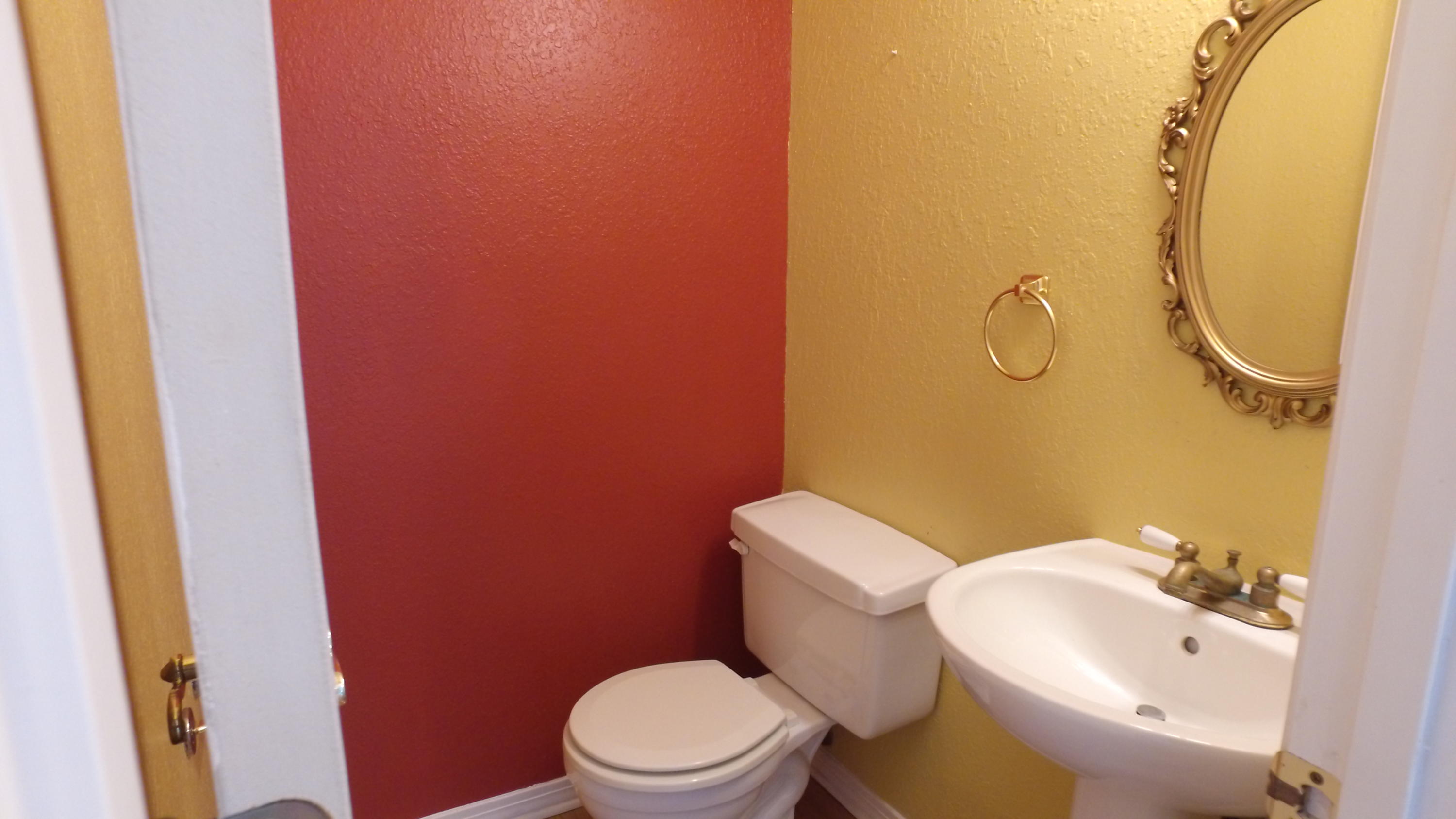 564 Ridge Lake Road Crestview, FL 32536 - Photo 33 of 58 a white toilet sitting next to a bathroom sink and a mirror