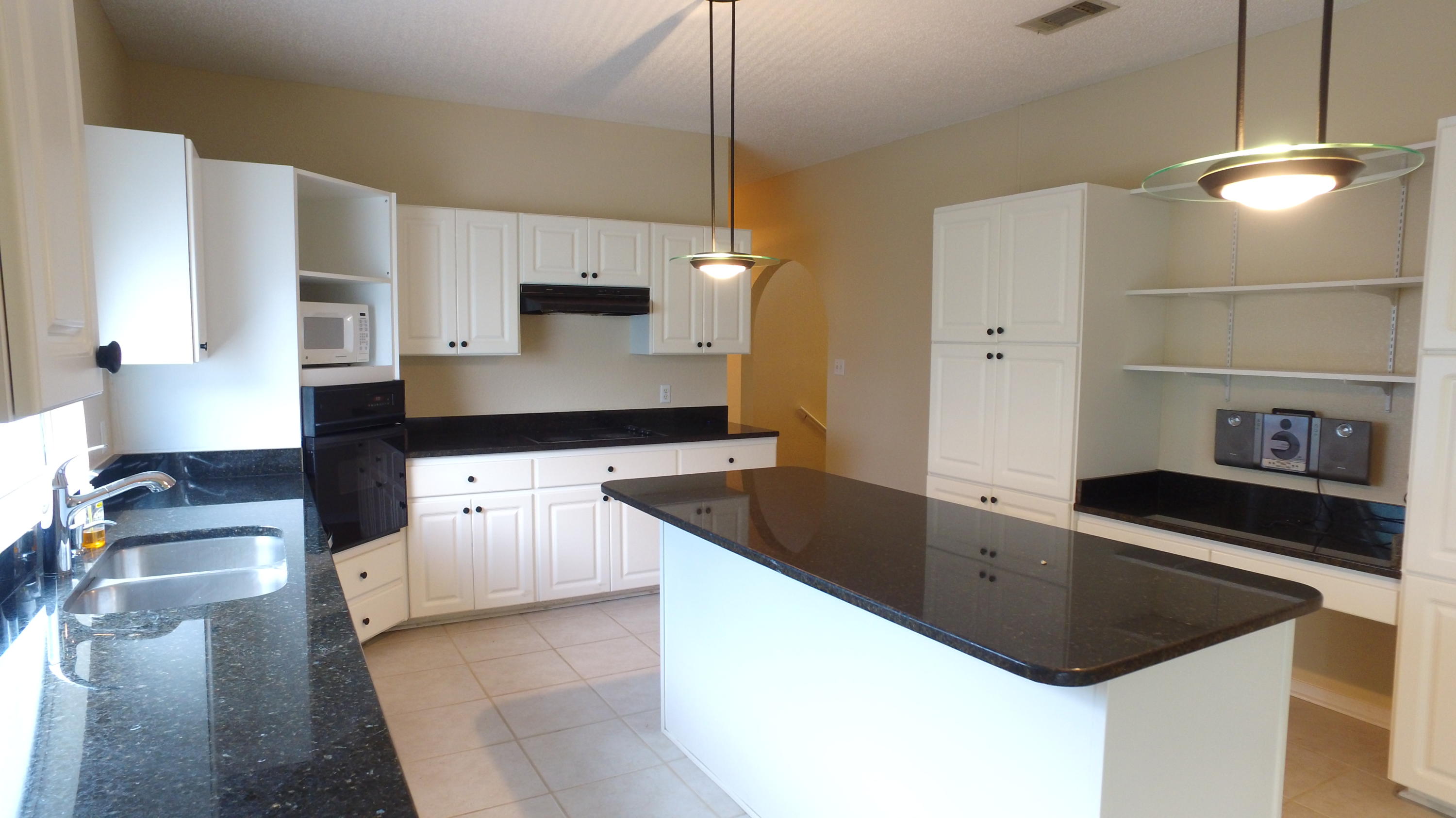 564 Ridge Lake Road Crestview, FL 32536 - Photo 34 of 58 a kitchen with granite countertop a sink and a stove top oven