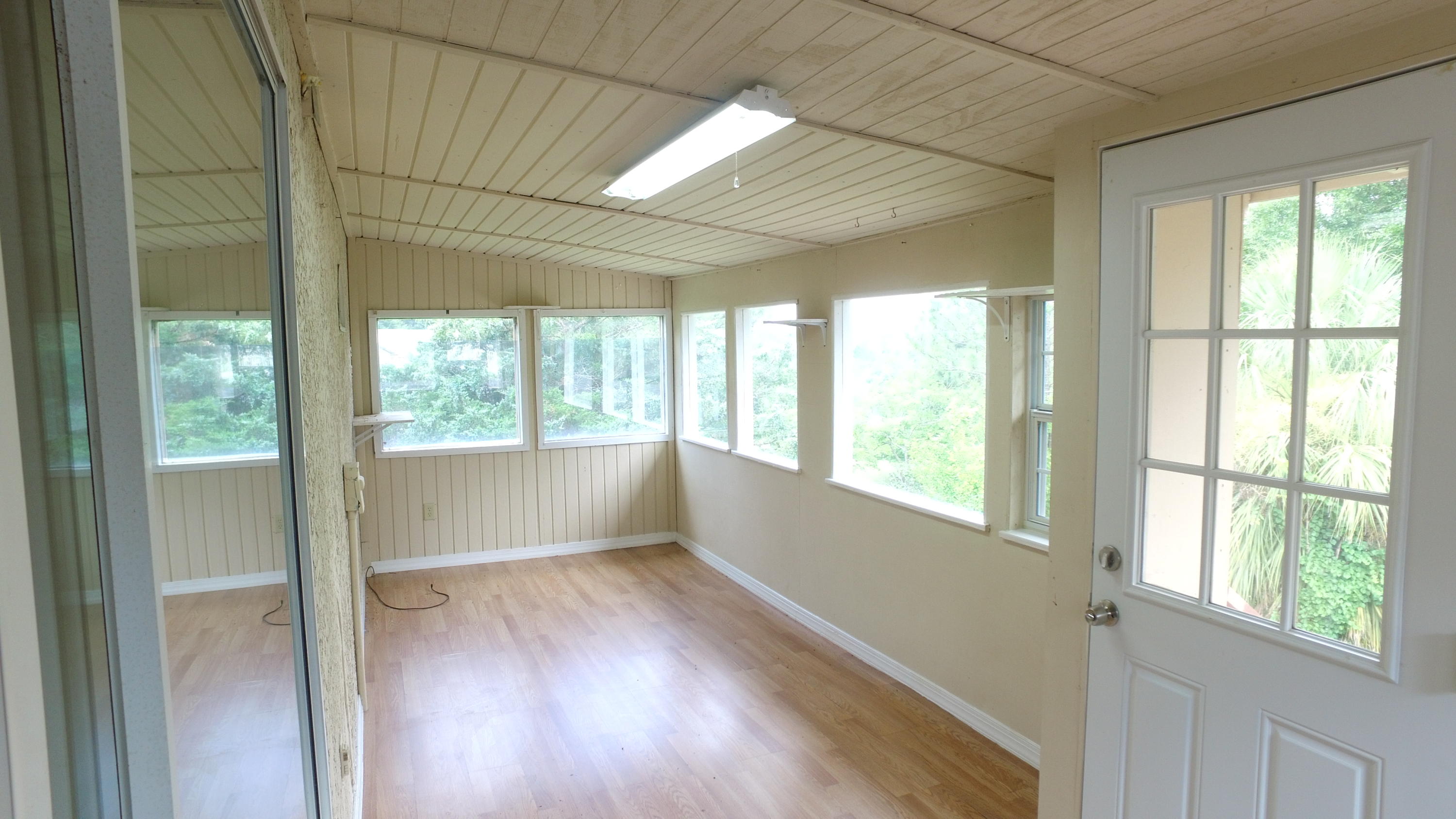 564 Ridge Lake Road Crestview, FL 32536 - Photo 36 of 58 a view of an empty room with wooden floor and a window