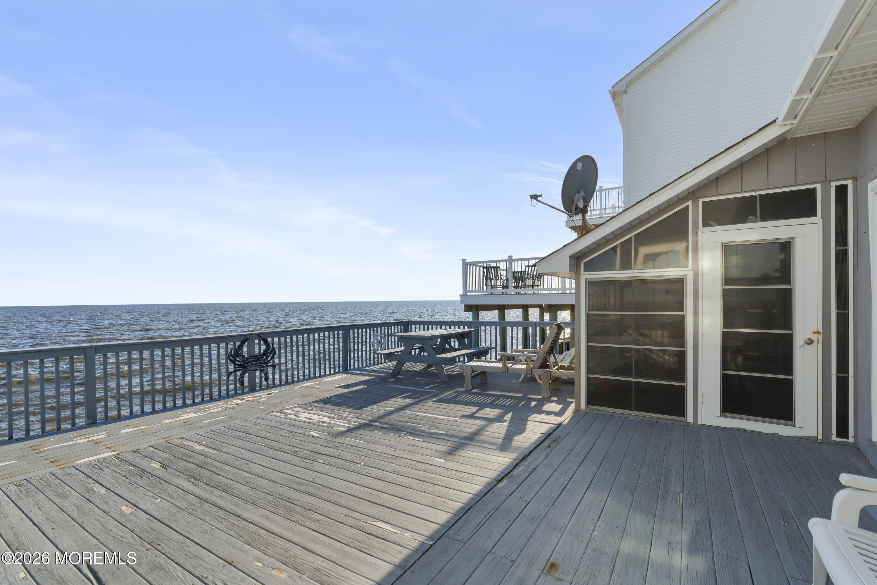 246 Cove Road Newport, NJ 08345 - Photo 17 of 21 a view of a balcony with wooden floor and a chair