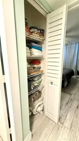 a bedroom with a bed wooden floor and window