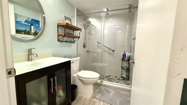 a large kitchen with stainless steel appliances granite countertop a refrigerator and a sink