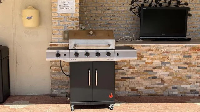 a view of a swimming pool with lawn chairs and a fire pit