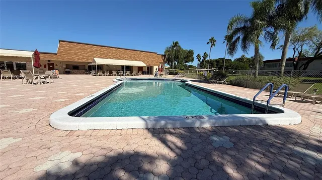 a view of a patio with swimming pool table and chairs