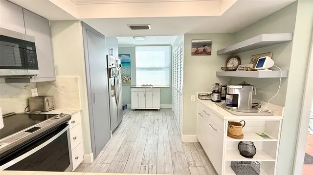 a view of a kitchen with fridge and rack