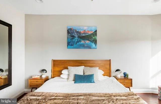 a bedroom with a bed and wooden floor