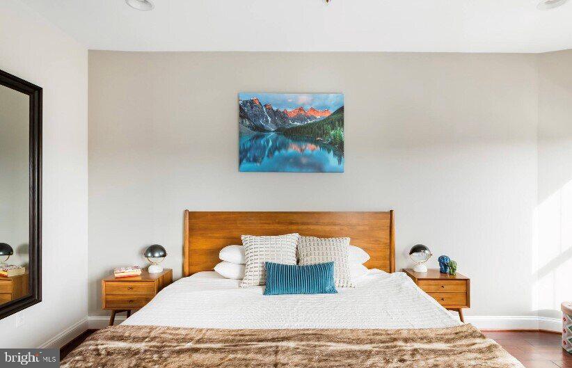 1904 Vermont Avenue Northwest, Unit B Washington, DC 20001 - Photo 13 of 26 a bedroom with a bed and wooden floor